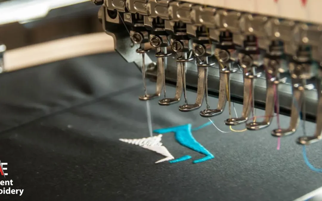 A close up of a sewing machine at work, stitching fabric on a table, highlighting custom embroidery techniques.